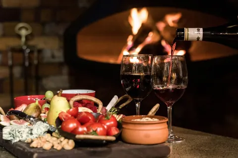 a glass of wine beside the fireplace